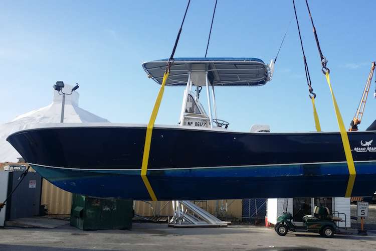 Tender boat being lifted in a shipyard