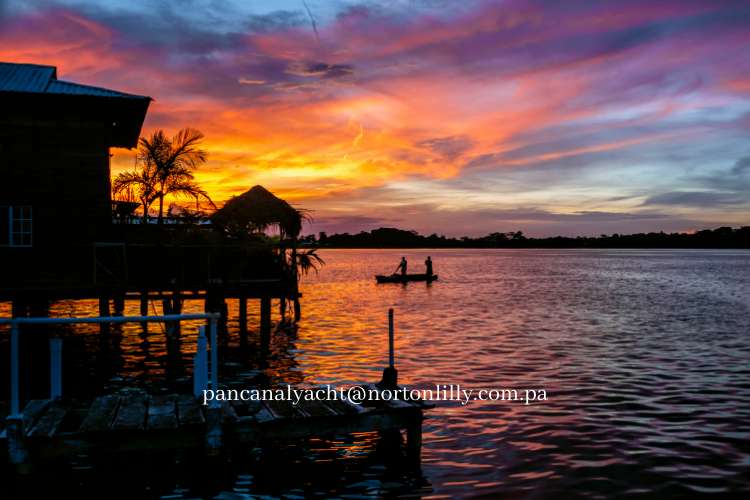 view of the bay at sunset with stilt house