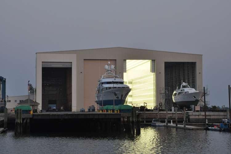 Image of superyacht drydocking in front of a shipyard